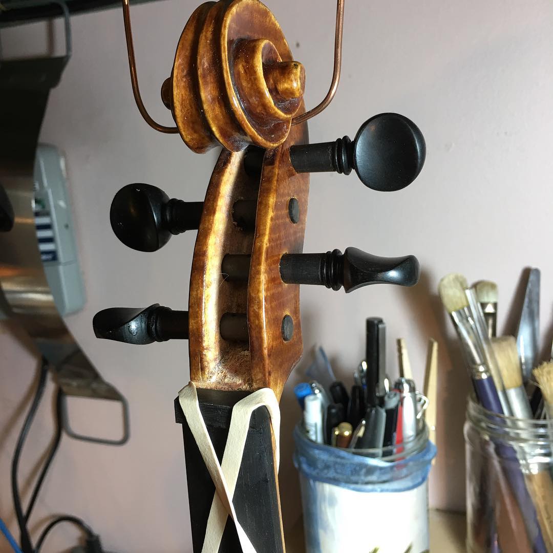 Fingerboard attached, holes reamed, pegs set, nut glue setting up; violin Edward